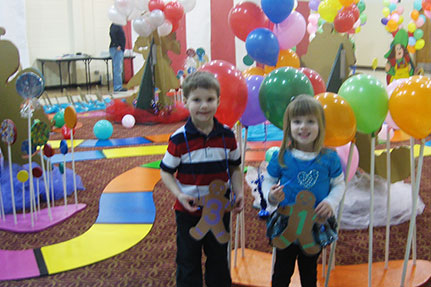 Two Kids Getting Picture Taken In Front of Life-Si